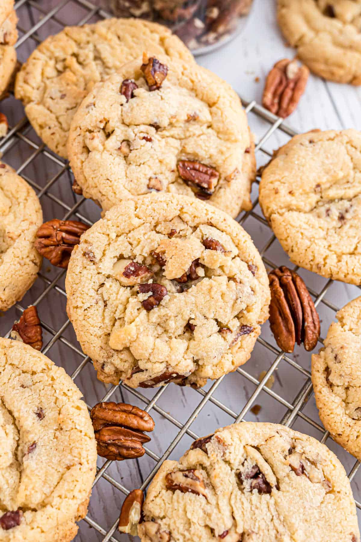 Butter pecan cookies on a wire cooling rack.