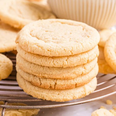 Stack of sugar cookies on a wire cooling rack.