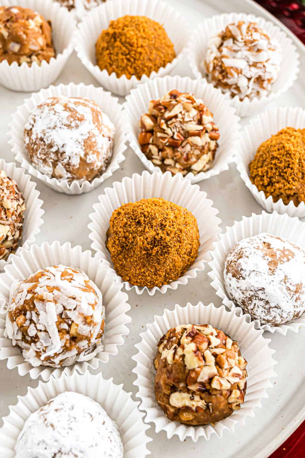 Rum balls served on a white platter.