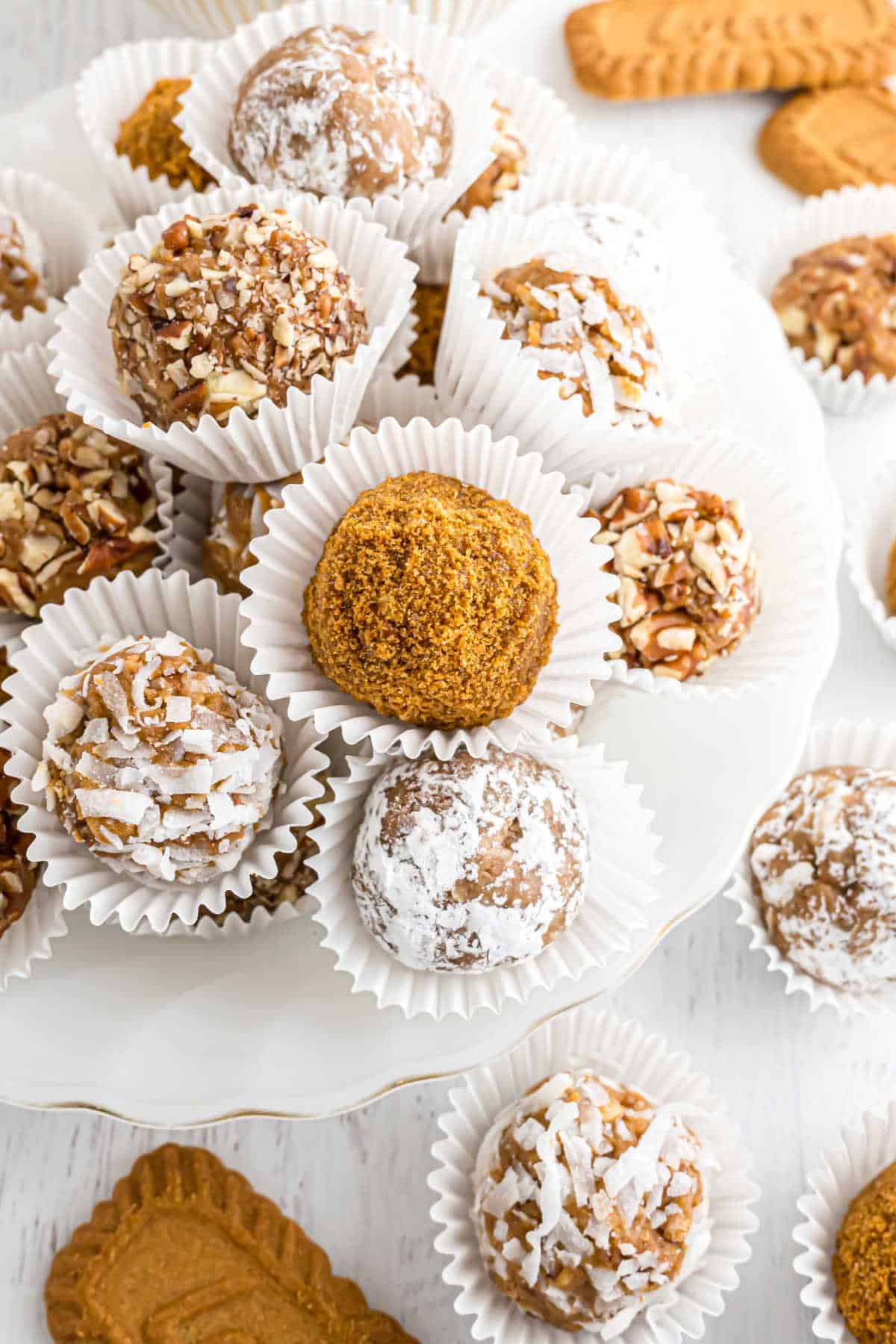 Rum balls stacked in paper liners.