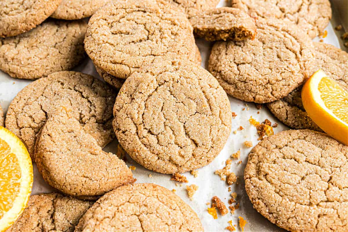 Cardamom cookies with orange on a piece of parchment paper.