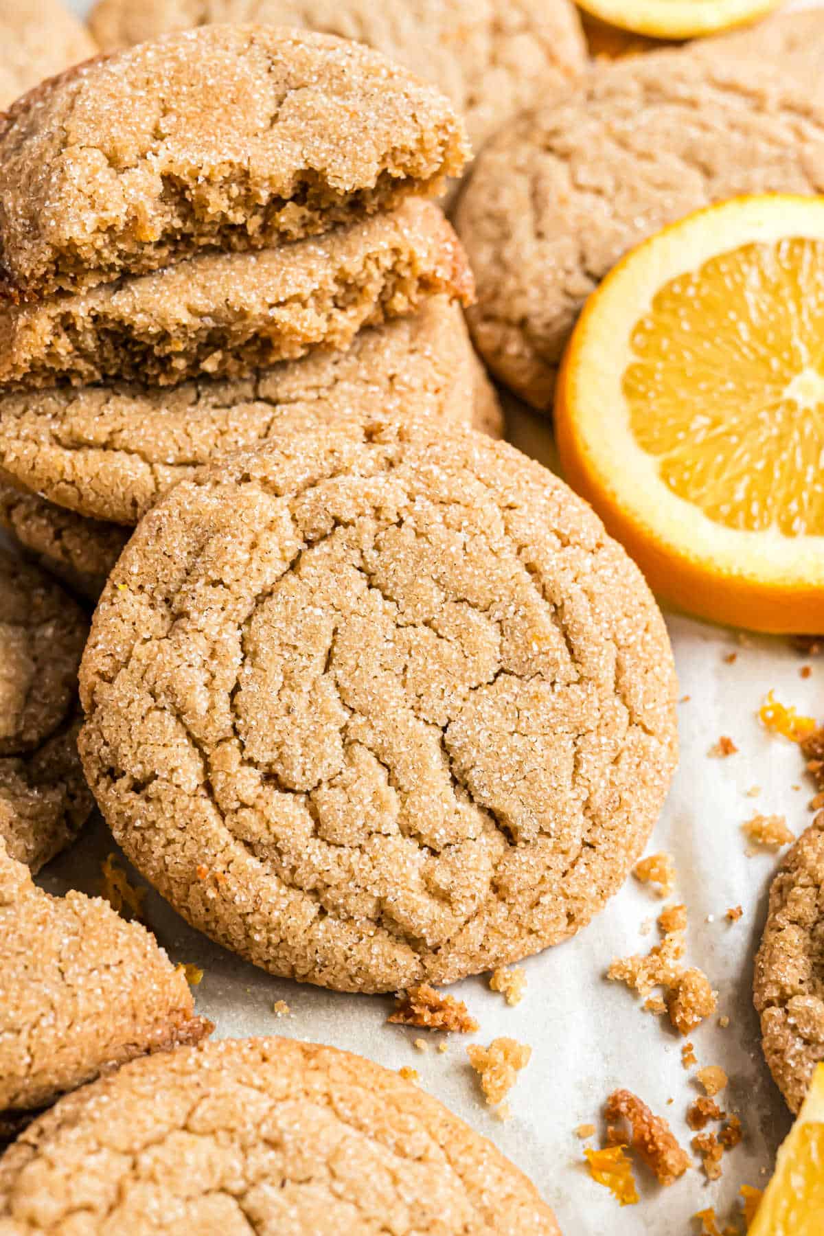 Cardamom cookies stacked on parchment paper.