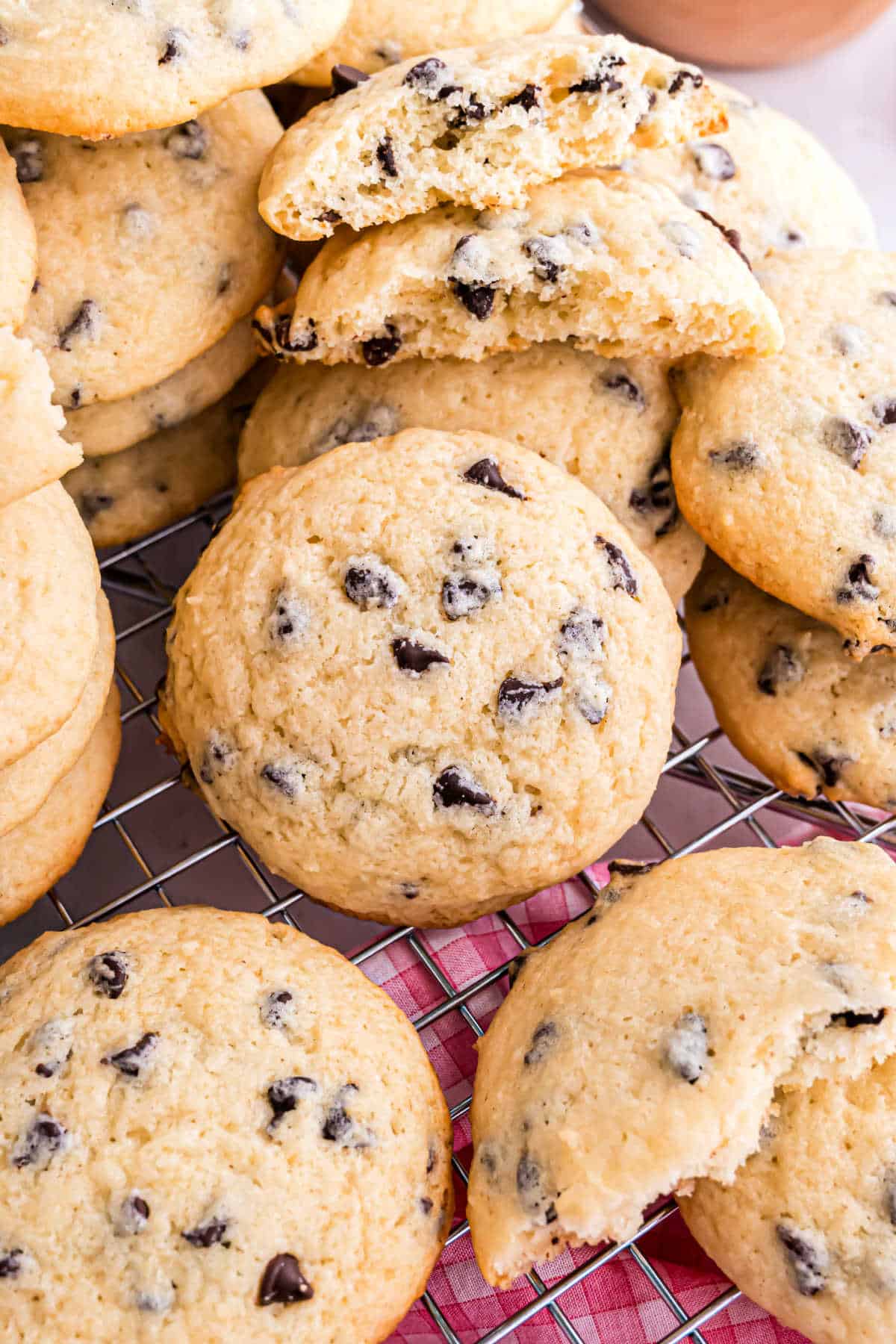 Chocolate chip ricotta cookies stacked on a wire cooling rack.