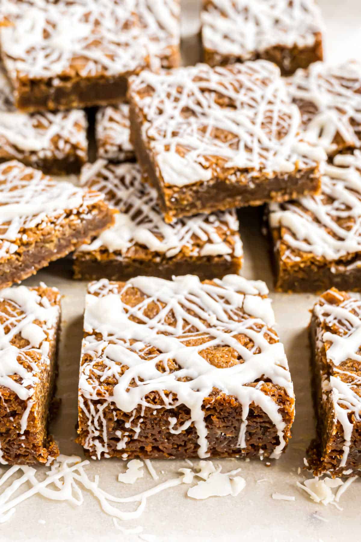 Gingerbread blondies with icing on parchment paper.