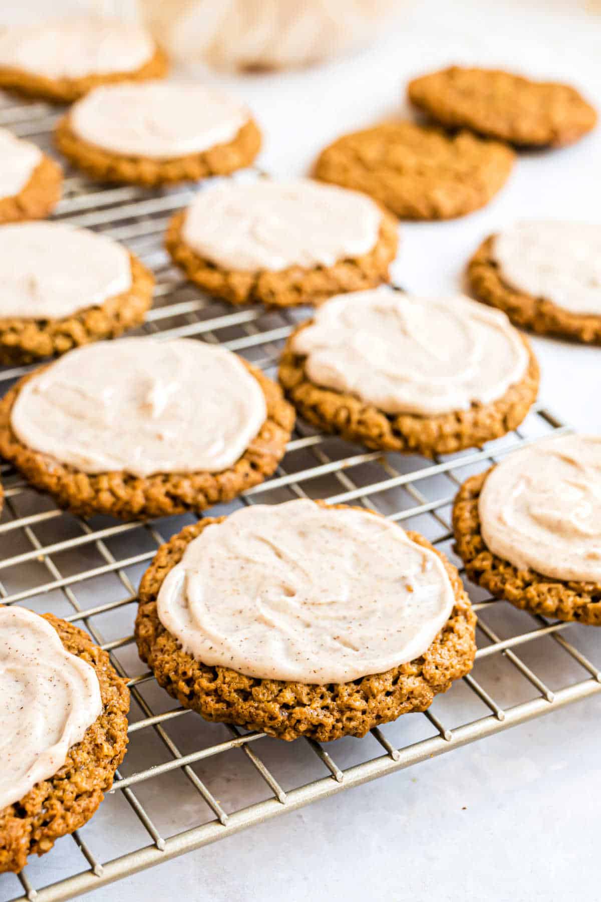 Iced gingerbread cookies with oatmeal on a cooling rack.