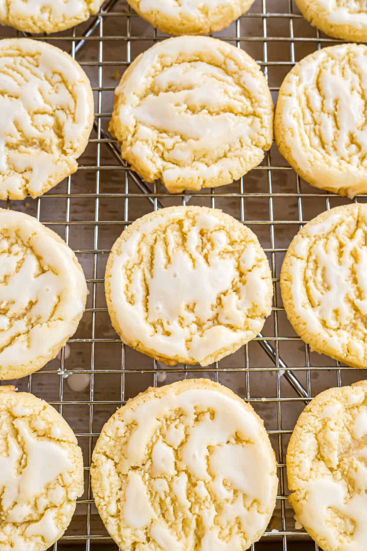 Lemon cookies cooling on a wire cooling rack.