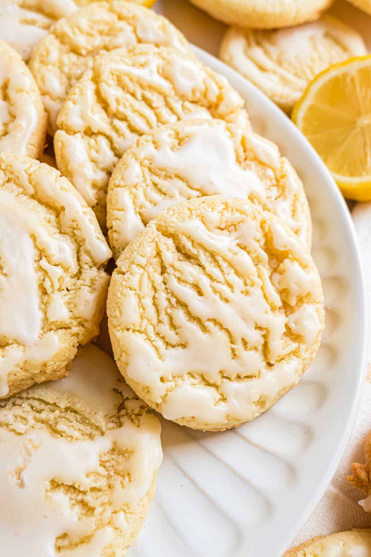 Lemon cookies on a white serving plate.