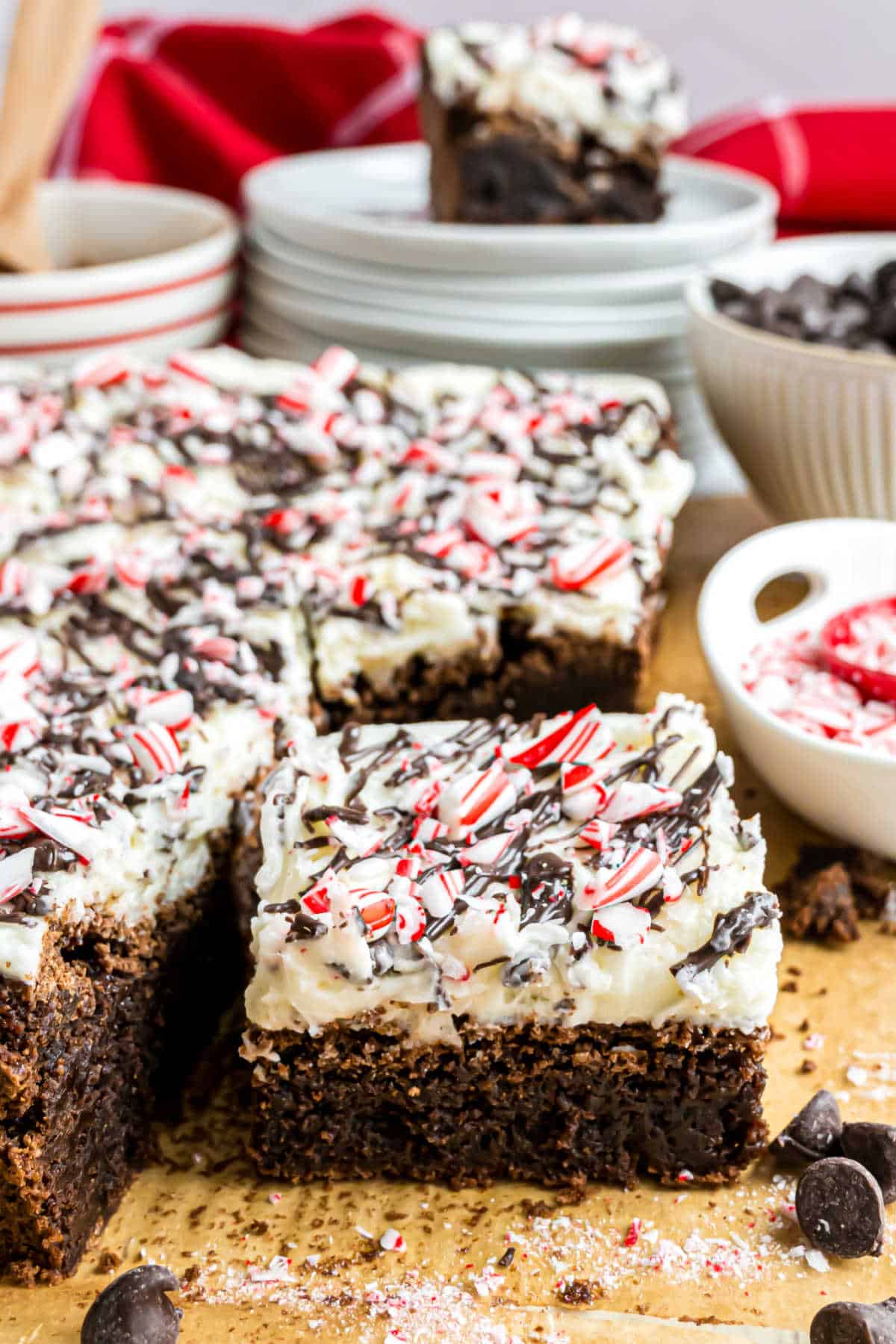 Chocolate brownies topped with peppermint frosting and candy canes.