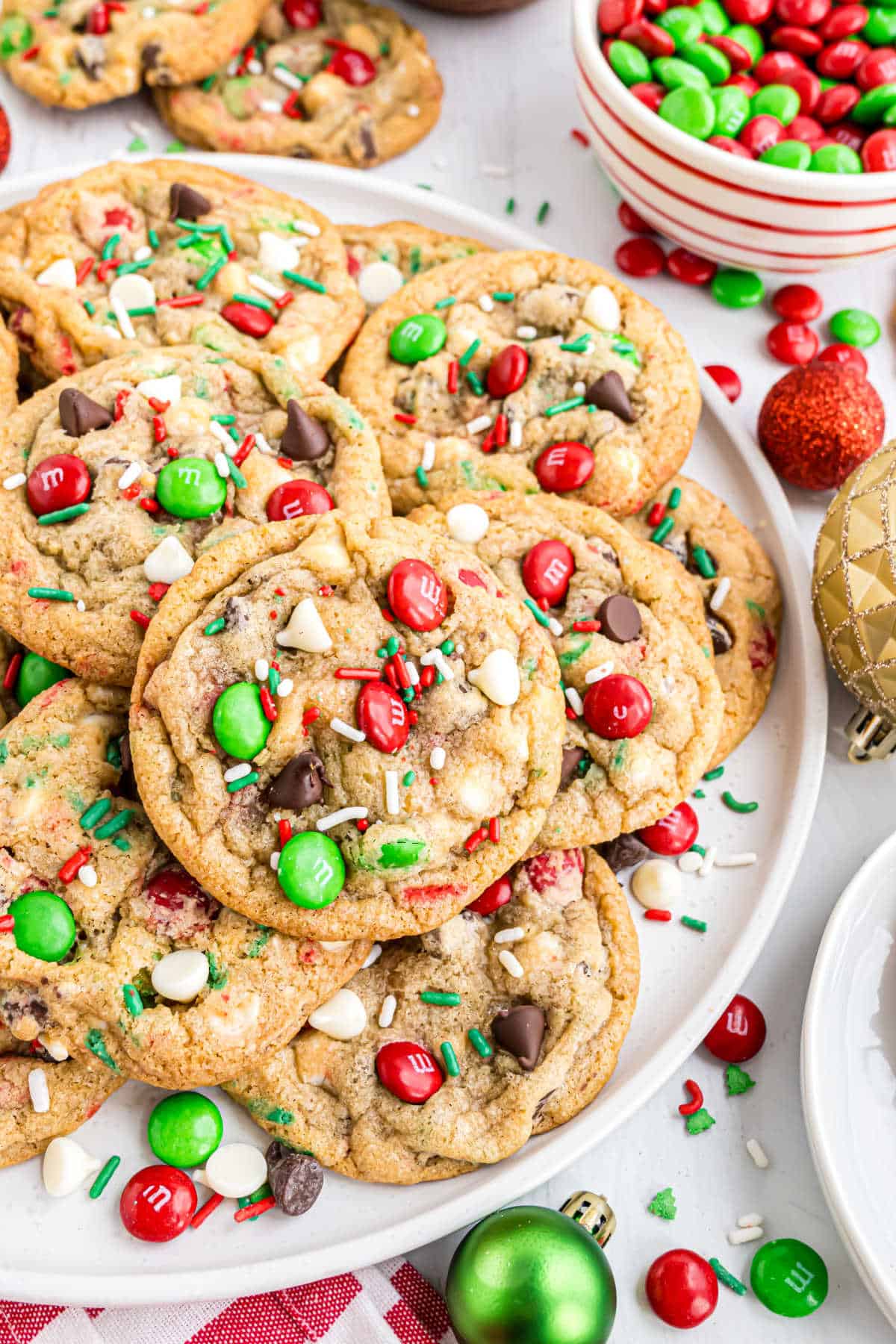 Holiday cookies stacked on a white serving plate.