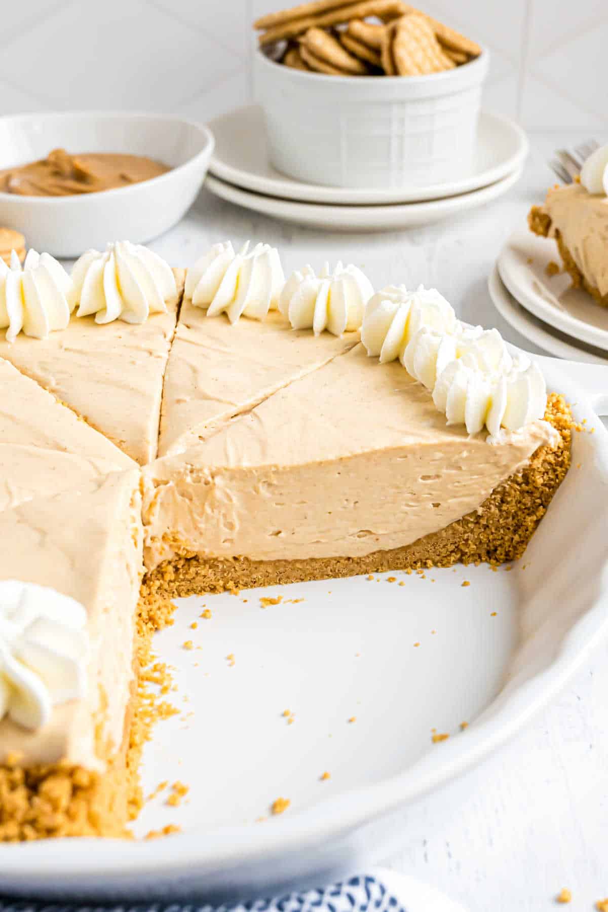 Peanut butter pie with several slices missing.