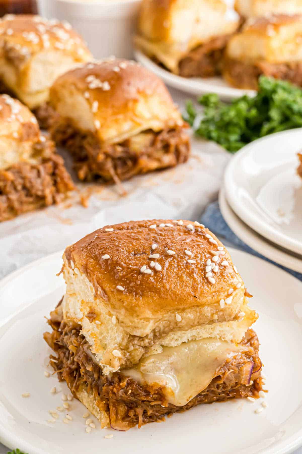 Pulled pork sliders served on a plate.