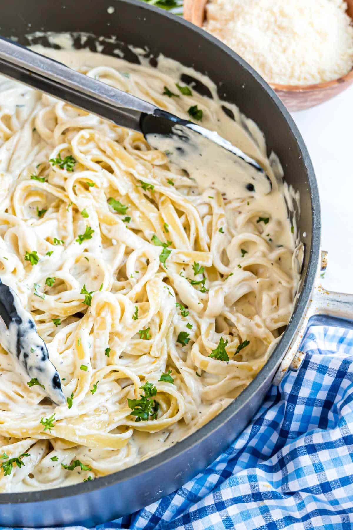 Alfredo sauce with pasta in a large skillet.