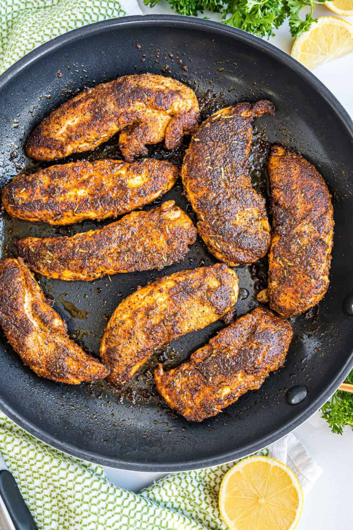 Blackened chicken in a skillet.