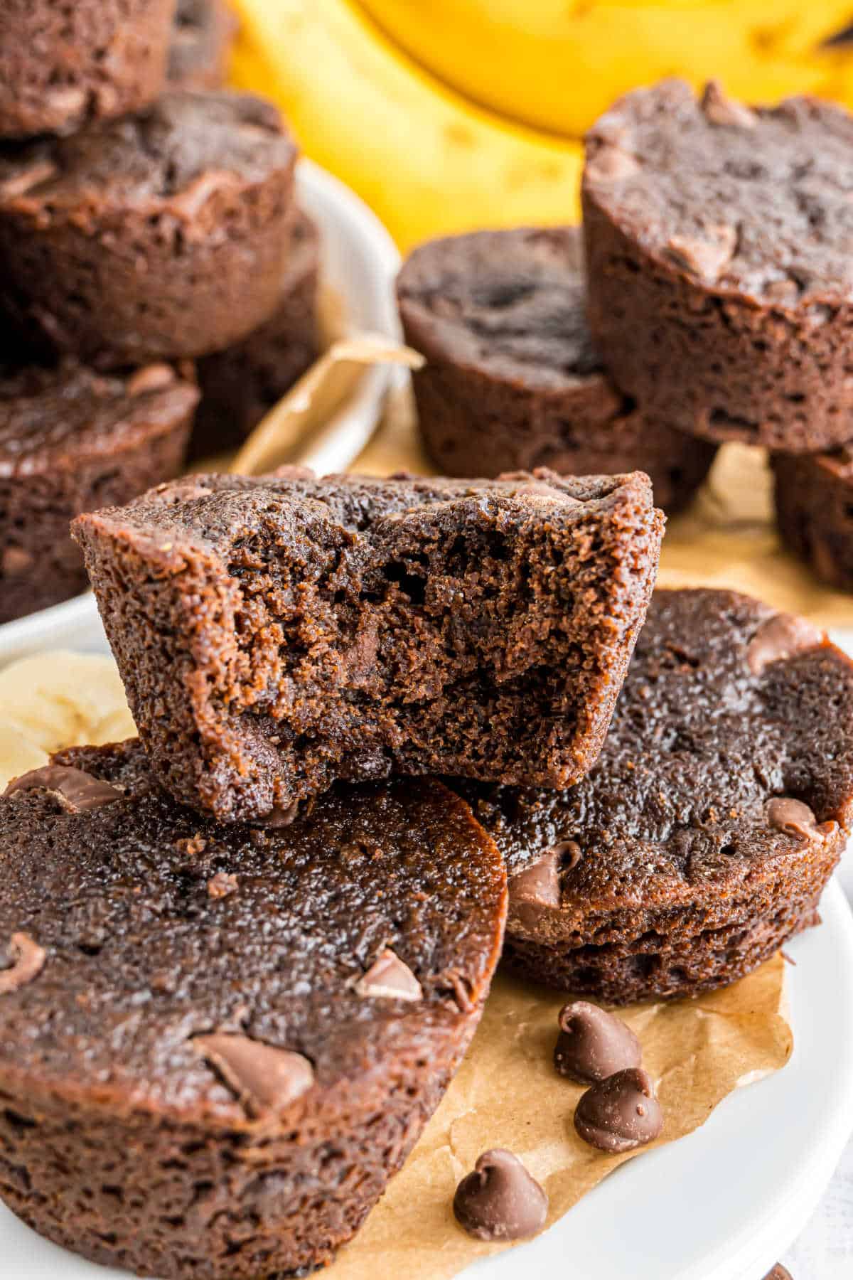 Stack of chocolate banana muffins on a plate.