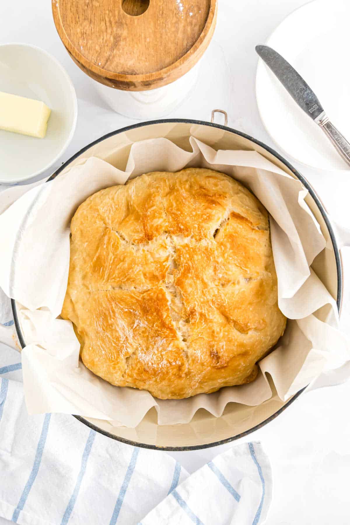 Loaf of bread in a dutch oven, baked to golden brown.