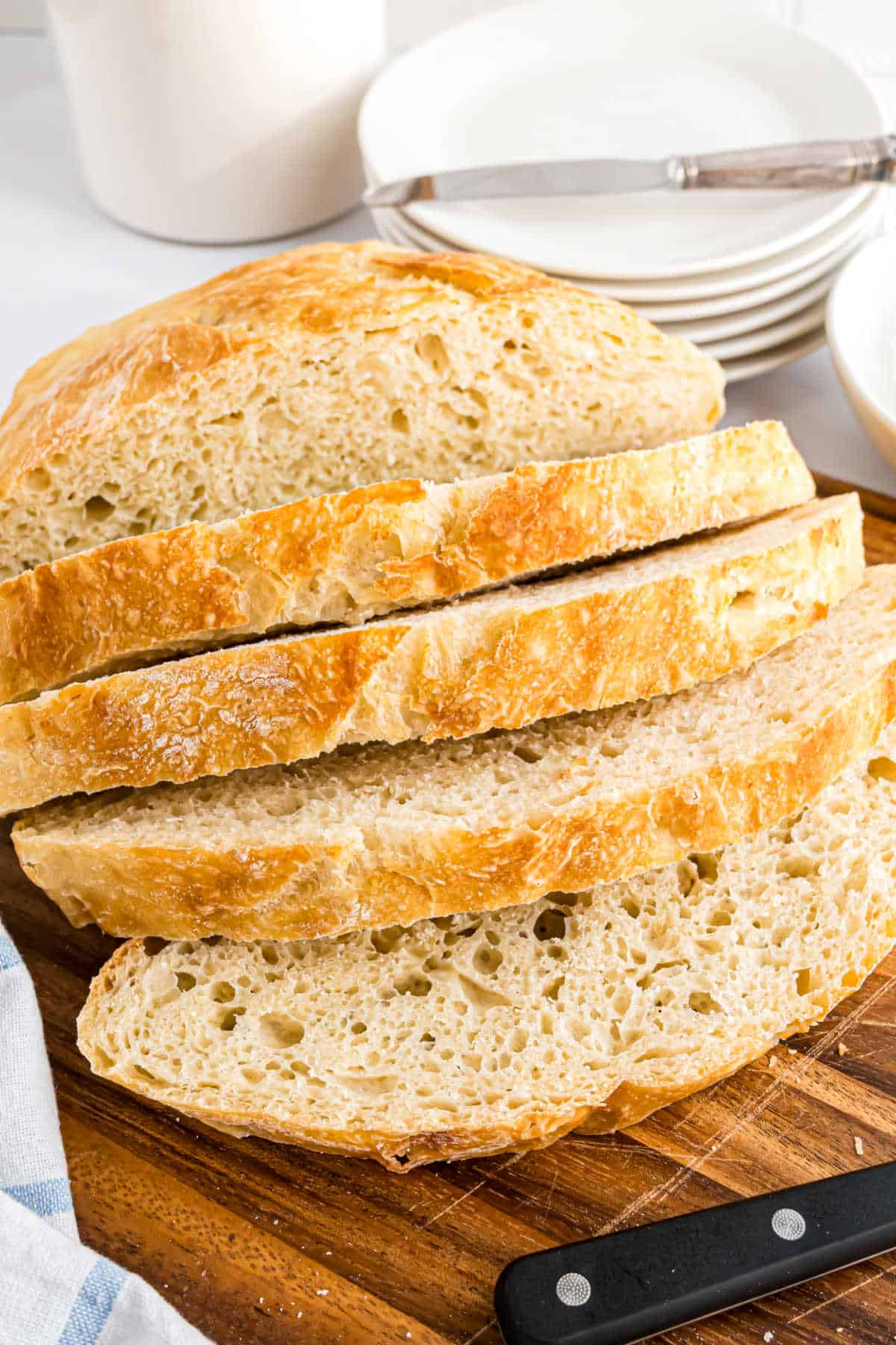 Slices of artisan bread on a cutting board.