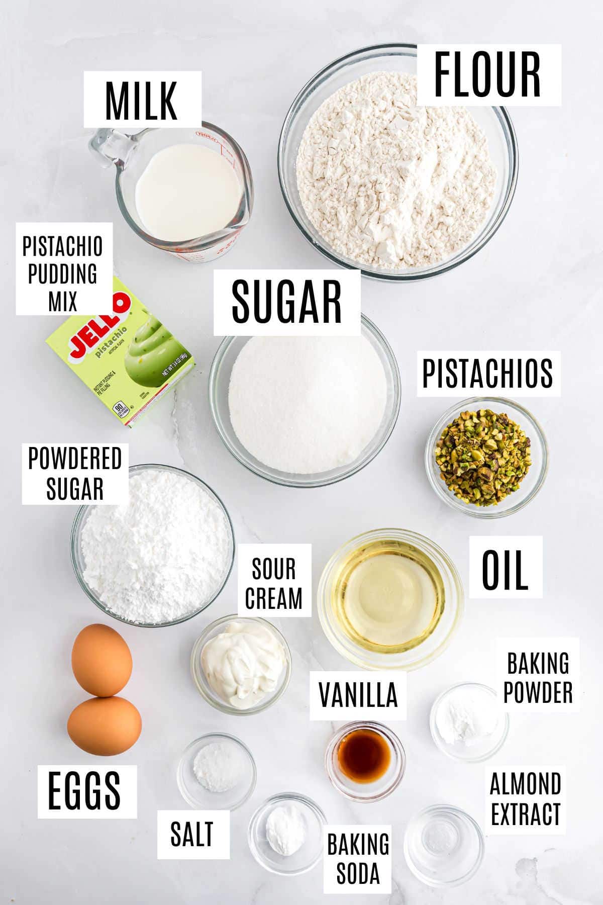 Labeled ingredients for baking pistachio bread: flour, milk, pistachio mix, sugar, pistachios, oil, eggs, extracts, sour cream, and more.