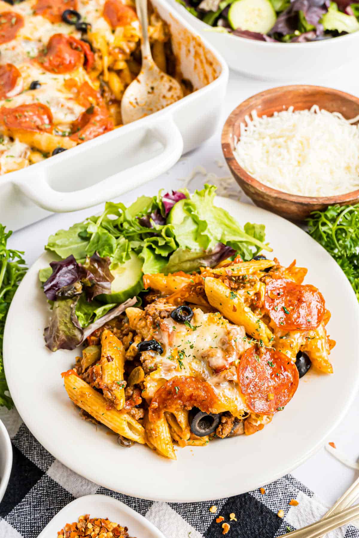 Pizza casserole served on a plate with a salad.