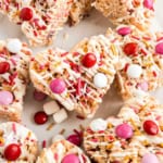 Colorful M&Ms and sprinkles make these heart-shaped Valentine’s Rice Krispie Treats festive and fun! I’ve perfected the Rice Krispie treat formula so you can be sure these will be a hit!